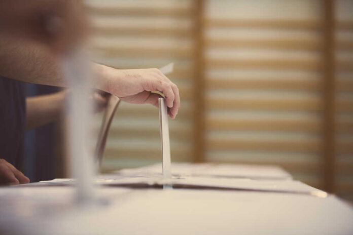 Hand,Of,A,Person,Casting,A,Ballot,At,A,Polling