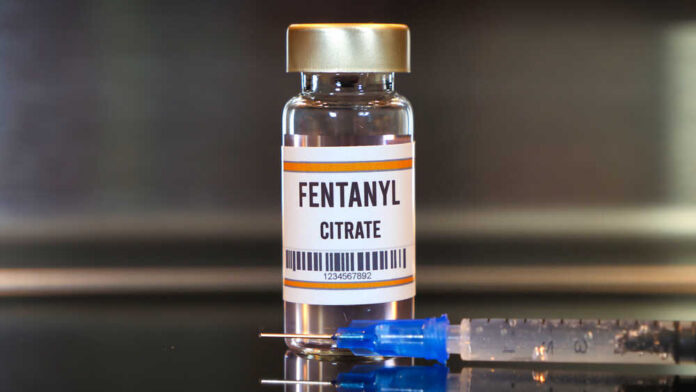 Fentanyl,Drug,And,Syringe,On,Black,Table,With,Reflections,And