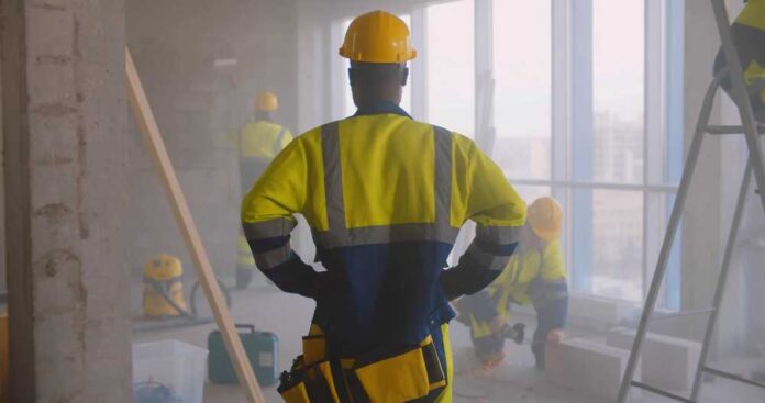 Back,View,Of,African-american,Foreman,In,Uniform,Supervising,Team,Of