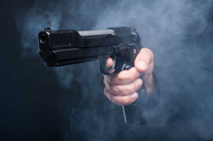 Closeup,Of,Gun,In,Boss,Mafia,Hand,On,Black,Background