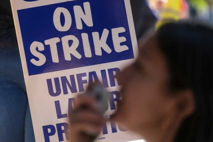 People,Holding,Signs,Take,Part,In,A,Protest,At,The