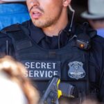 Secret Service officer wearing black tactical gear.