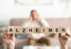 Alzheimer’s Breakthrough Stuns Scientists Wooden blocks spelling Alzheimer with blurred person behind