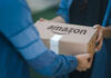 Washington Court BREAKS Amazon’s Shield Two people exchanging an Amazon package, outdoors.