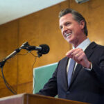 Man speaking at podium with microphone