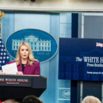 Person speaking at White House press briefing podium