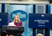 Person speaking at White House press briefing podium