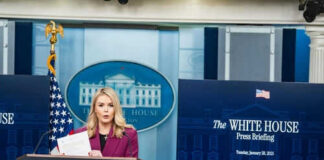 Person speaking at White House press briefing podium