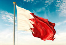 Iran Strike Rattles Bahrain’s “Safe” Zone Flag of Bahrain waving against a blue sky