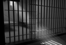 Sunlight streaming through prison cell bars.