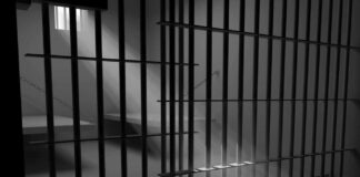 Sunlight streaming through prison cell bars.