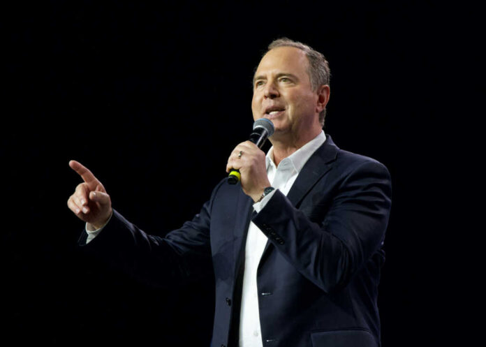 adam-schiff-speaking2391508289jpg Man speaking into microphone against dark background