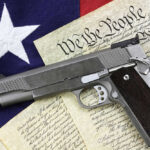 Nationwide Gun Law Overhaul: What It Means For You Pistol on Constitution and flag background.