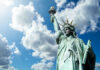 Statue of Liberty under a cloudy blue sky