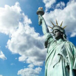 Statue of Liberty under a cloudy blue sky