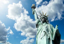 Statue of Liberty under a cloudy blue sky