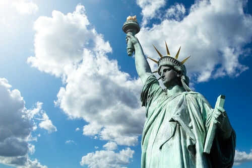 Statue of Liberty under a cloudy blue sky