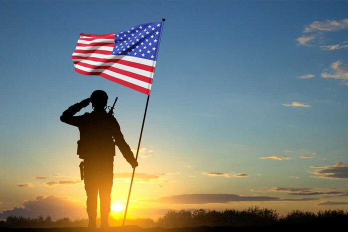 militaryveteranid2367993605jpg soldier holding flag facing sunset
