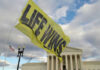 South Dakota’s Pro-Life Laws Tightened—Outrage Ensues Yellow flag with life wins near courthouse building