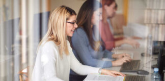 Female students engaged in a study session using laptops