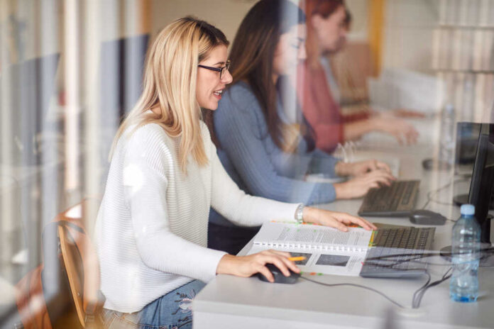 Female students engaged in a study session using laptops