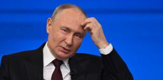 A political leader appearing thoughtful during a press conference