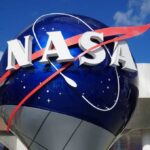 Moon Return Countdown: NASA’s Risky Call NASA logo displayed on a large globe structure