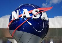 Moon Return Countdown: NASA’s Risky Call NASA logo displayed on a large globe structure