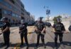 Police officers in riot gear standing on a street during a protest