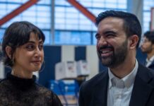 Jewish Leaders Demand Accountability from NYC Mayor Two individuals engaged in conversation at a polling station