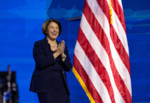 I dont know who this is clapping near flag