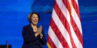 I dont know who this is clapping near flag