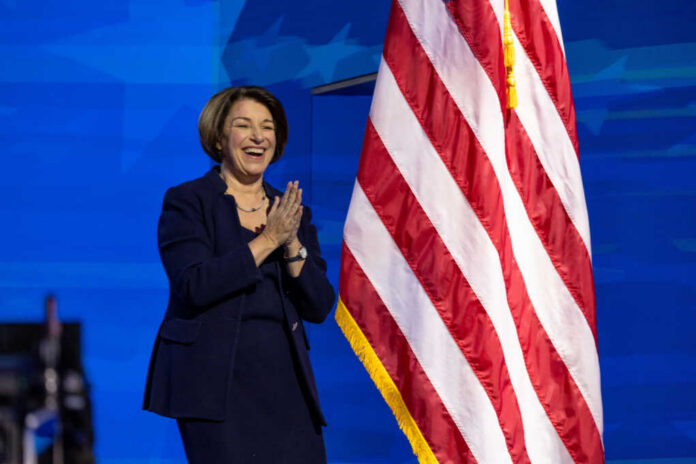 I dont know who this is clapping near flag