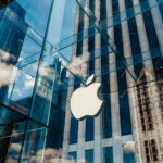 Apple’s Age Barrier: Everyday Users Trapped Apple store glass building with cloudy sky reflection