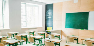 Empty classroom with desks and a chalkboard