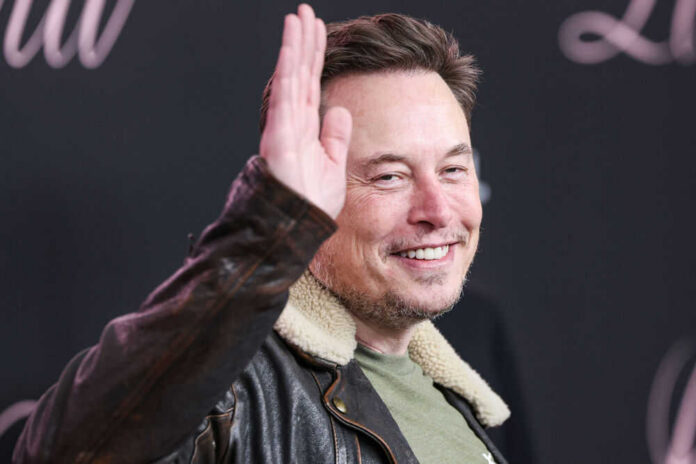 Man in leather jacket smiling and waving