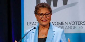 Woman speaking at a podium in blue jacket