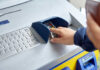 Person using an ATM keypad to perform a transaction