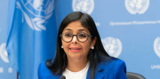 A woman in a blue suit speaking at a United Nations conference