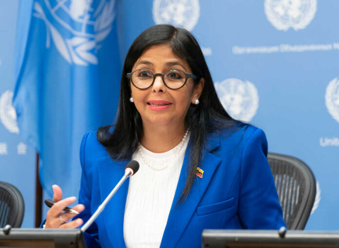 A woman in a blue suit speaking at a United Nations conference