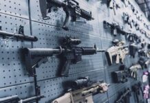 A wall displaying various firearms in a gun shop