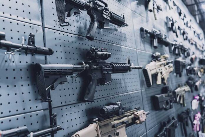 A wall displaying various firearms in a gun shop