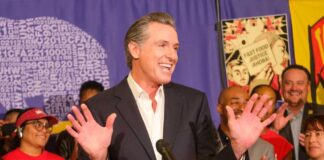 California governor speaking at a public event with supporters