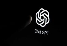 Close-up of a hand reaching towards the ChatGPT logo on a smartphone screen