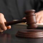 Ohio’s Corrupt Elite: Justice Finally Served A judge's hand holding a gavel above a wooden block