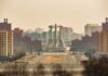 View of a large monument surrounded by buildings in Pyongyang