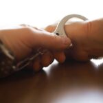 Guatemalan National Accused: Tragedy in Fairfax Close-up of a handcuff being secured on a wrist