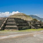 Ancient pyramid ruins under a clear blue sky