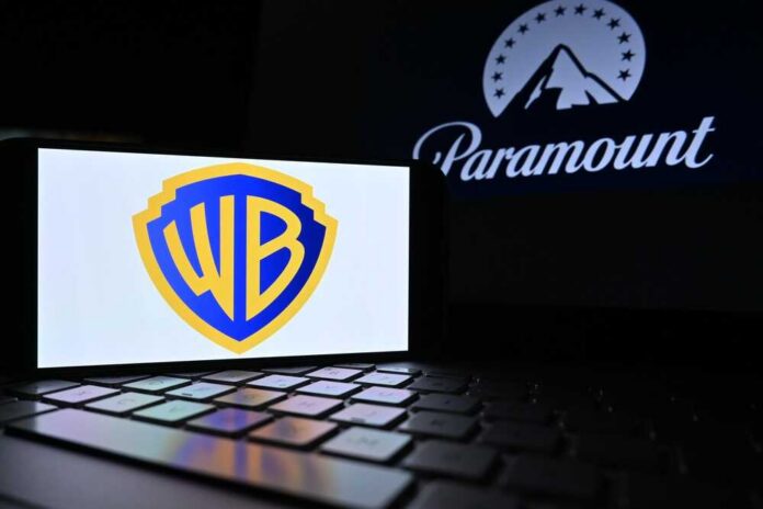 Warner Bros logo displayed on a smartphone with Paramount logo in the background