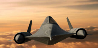 A stealth aircraft flying above clouds during sunset